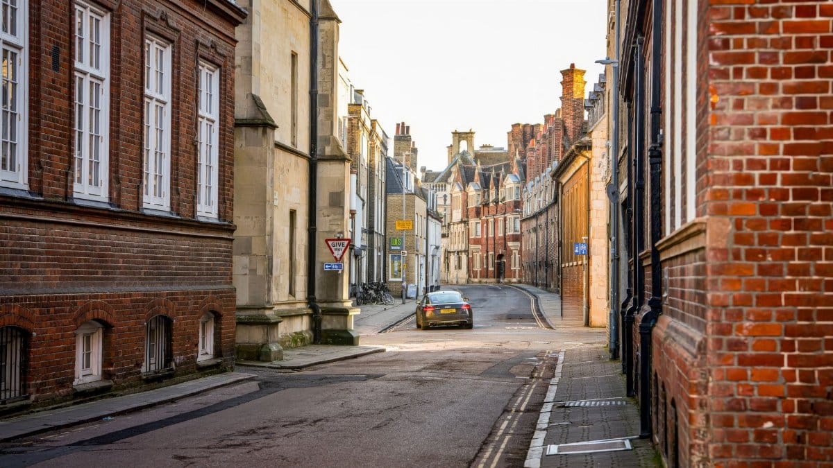 Charming street in Cambridge with historic architecture and cobblestone road.