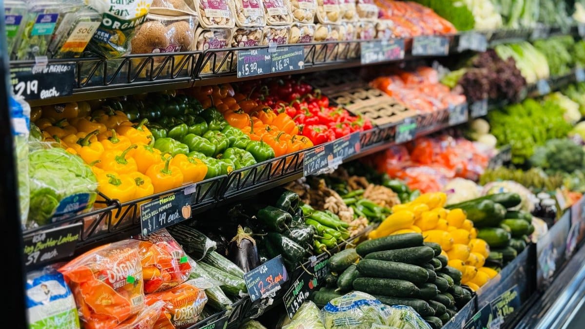Vibrant variety of fresh vegetables and fruits on grocery store shelves, showcasing healthy choices.
