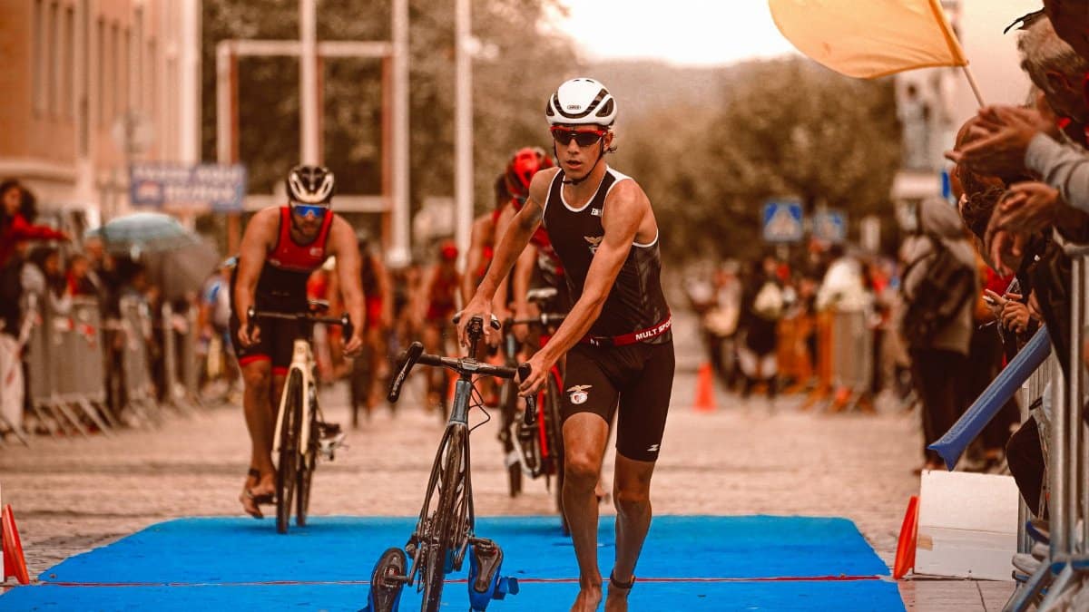Triathletes in action at the transition area during a competitive event, showcasing athleticism and determination.