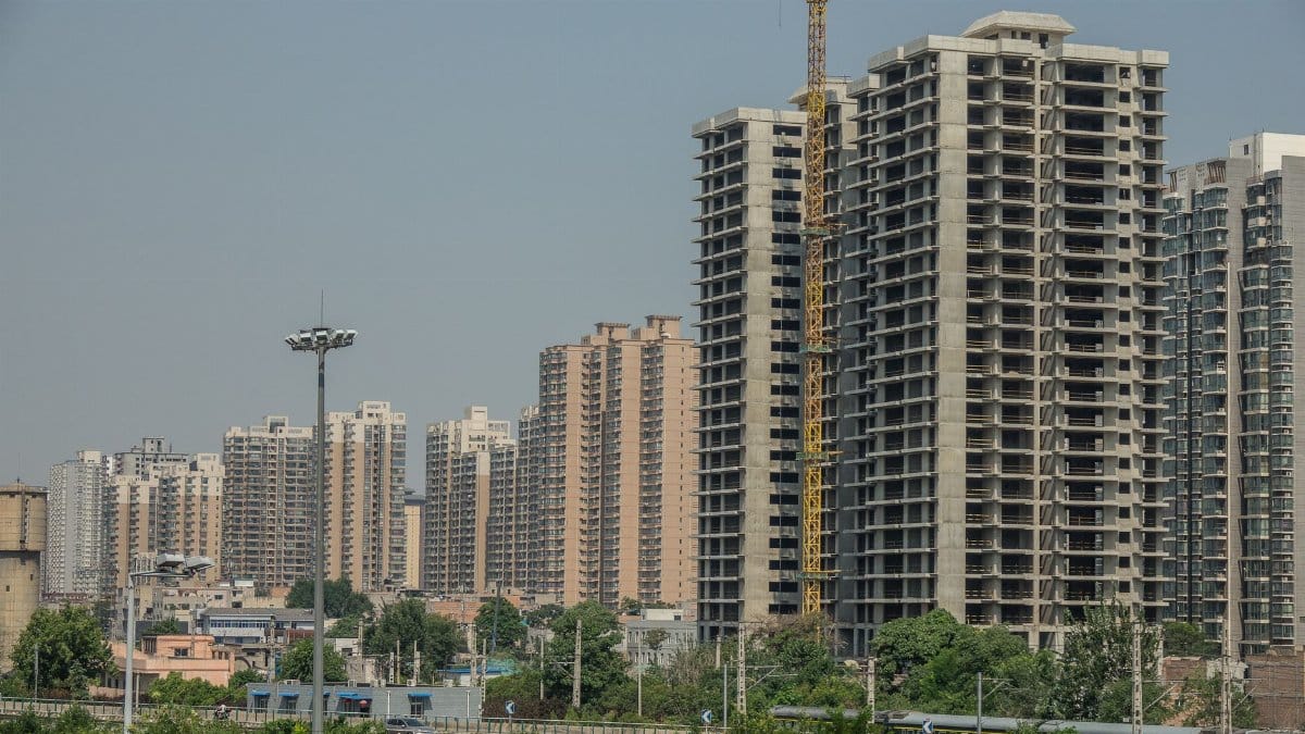 High-rise buildings under construction in an urban area showcasing city development.