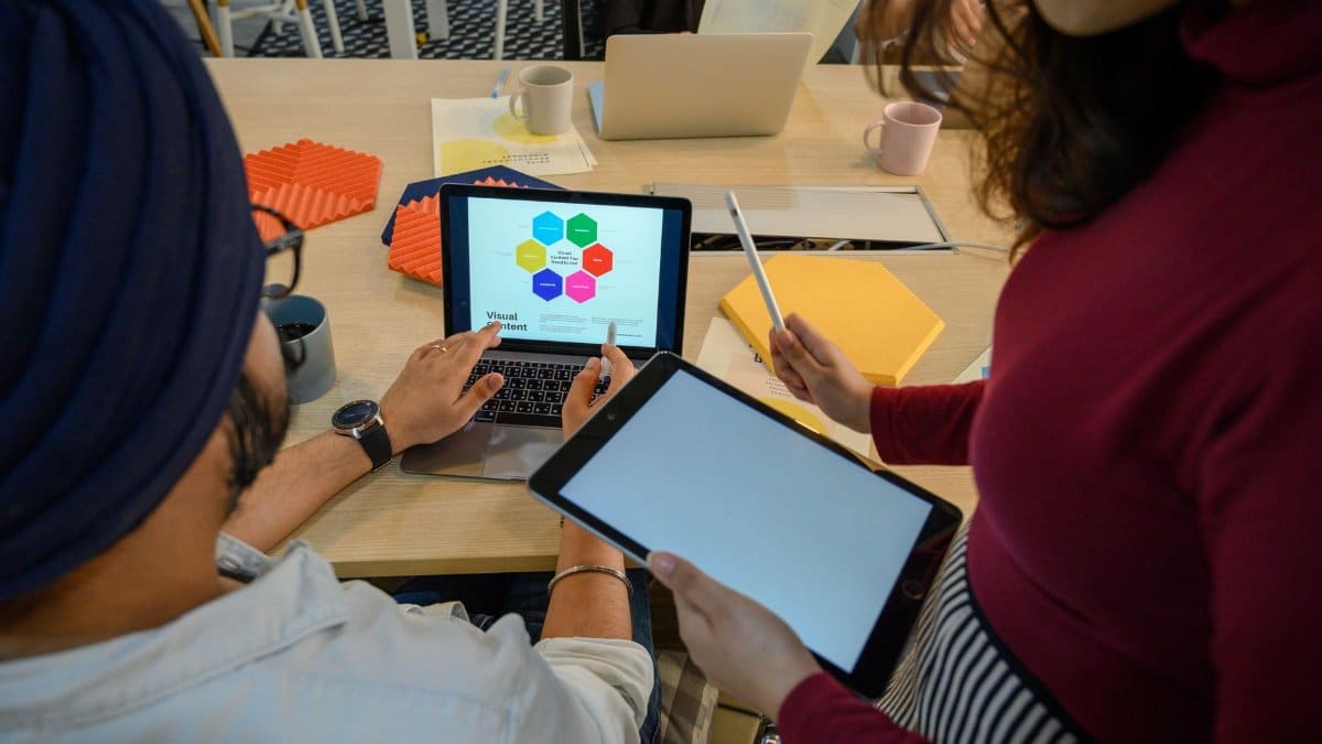 Creative meeting with digital devices in a modern office, showcasing teamwork and collaboration.