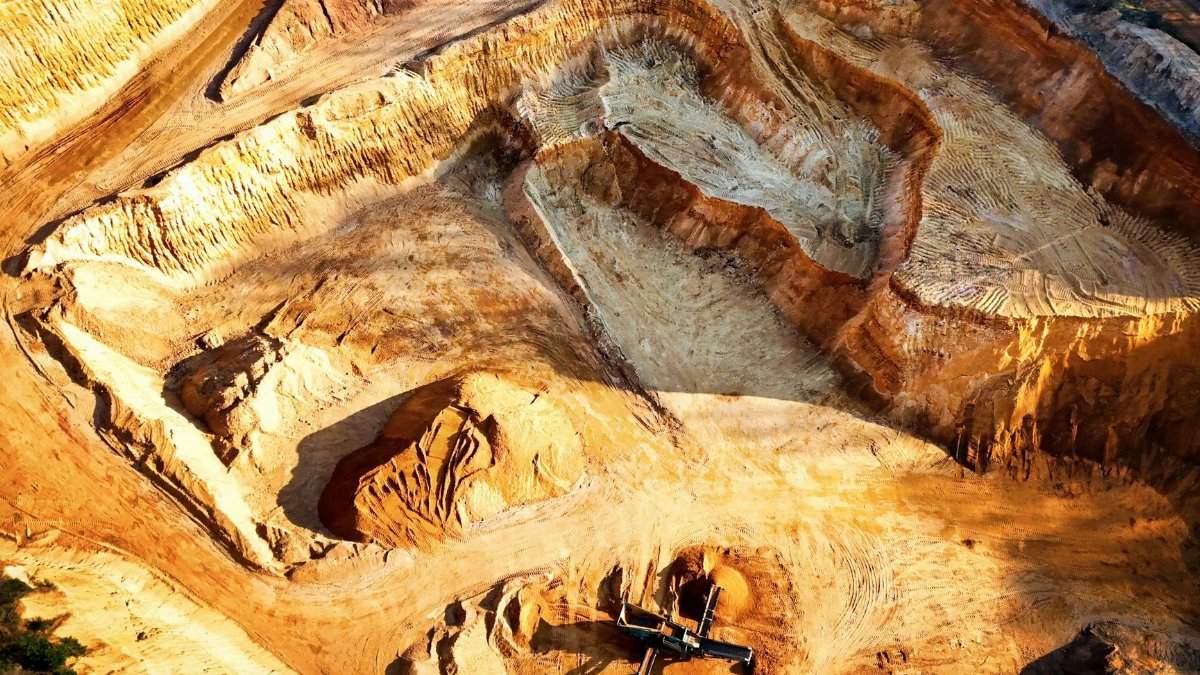 A striking aerial view of a large open-pit mine showcasing its excavation patterns.