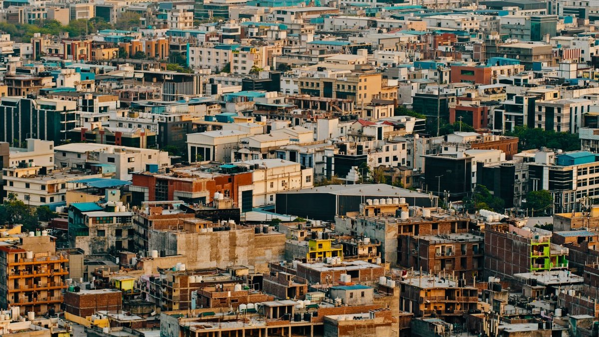 Aerial urban view showcasing densely packed residential and commercial buildings in an expansive cityscape.
