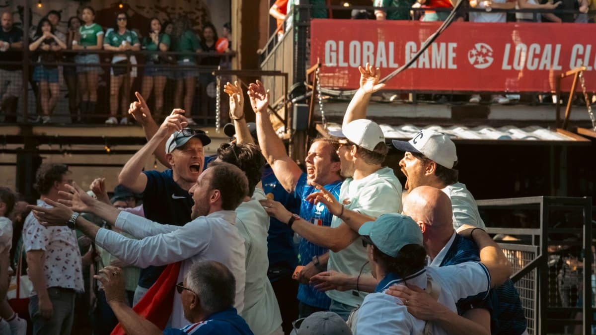 Excited sports fans celebrating a victory at an outdoor Chicago event, embodying joy and enthusiasm.