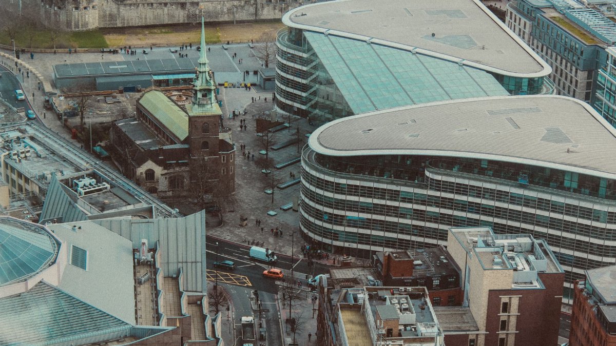 Aerial shot of modern buildings and a historic church in central London, England.