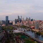 A stunning aerial view of the Philadelphia skyline with clear skies, capturing the cityscape and urban development.