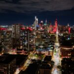 A breathtaking aerial view of Philadelphia's illuminated skyline at night, showcasing city lights and architecture.