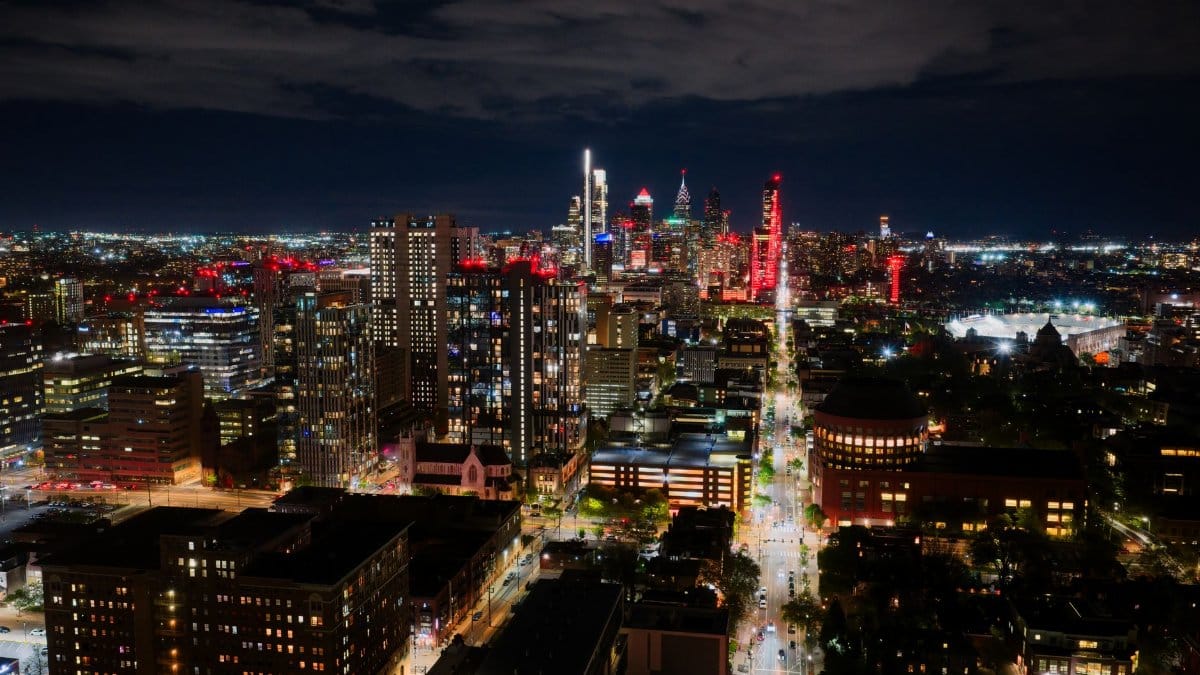 A breathtaking aerial view of Philadelphia's illuminated skyline at night, showcasing city lights and architecture.