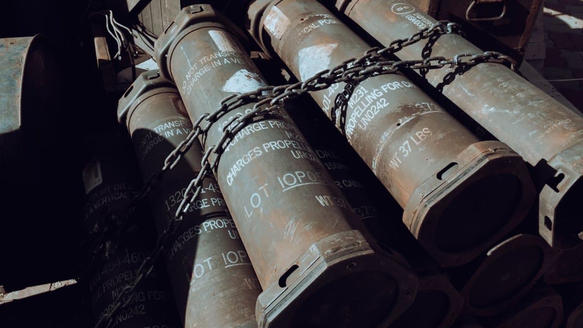 Close-up of chained military missile containers in a warehouse.