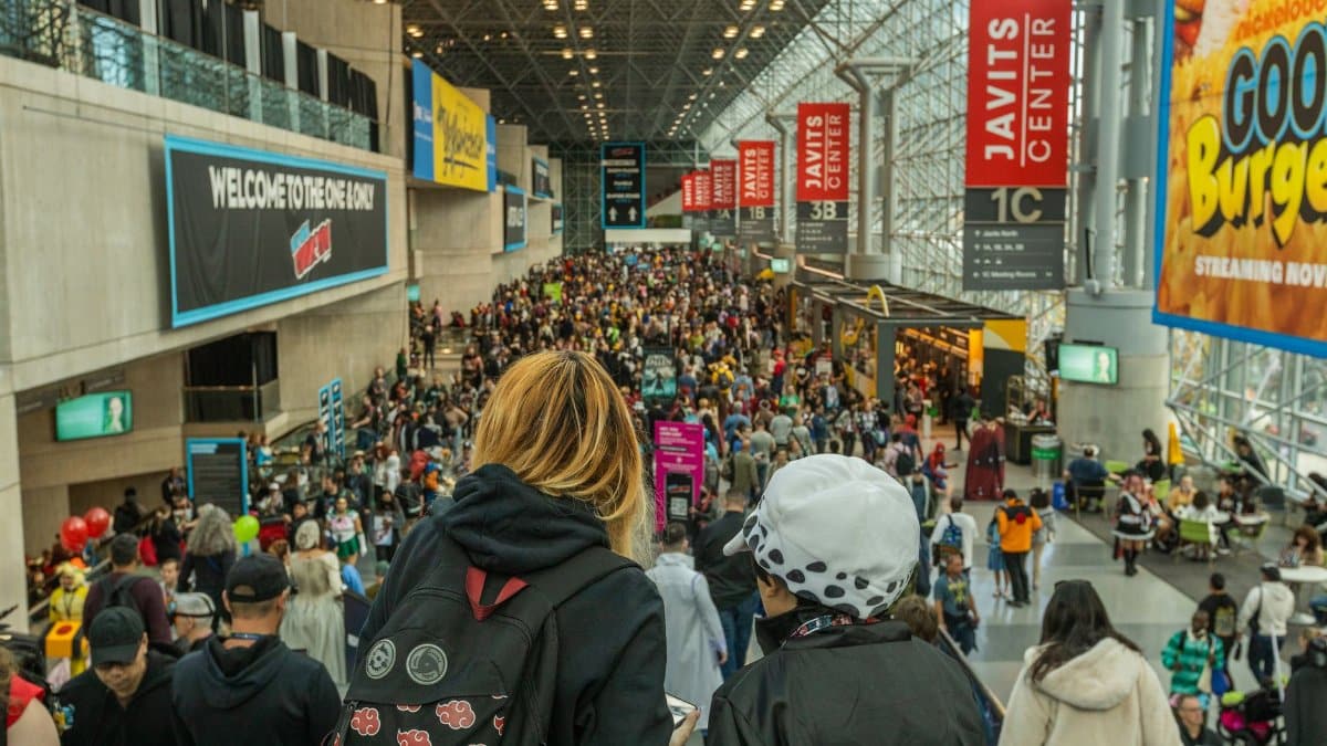 Lively crowd at New York Comic Con in Javits Center, showcasing cosplay and fan culture.