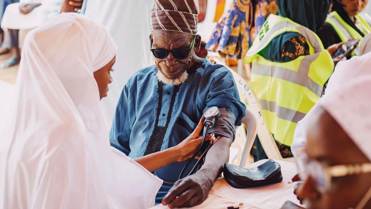 Elderly man receives medical care during community health outreach in Kaduna, Nigeria.