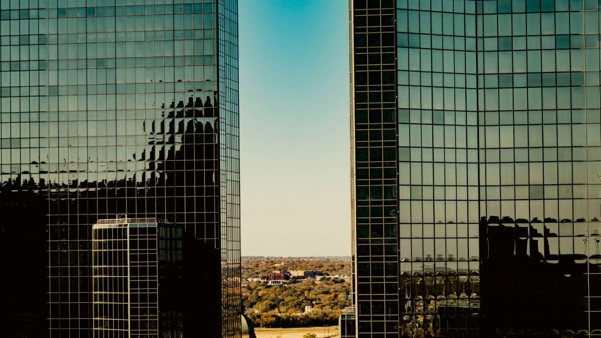 A view of modern glass skyscrapers in Fort Worth, Texas, reflecting the skyline.