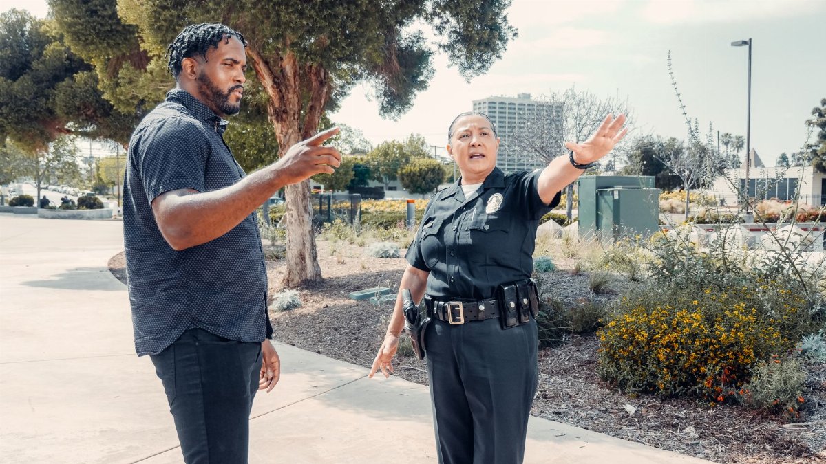 Police officer speaking with a man outdoors, showcasing community engagement.