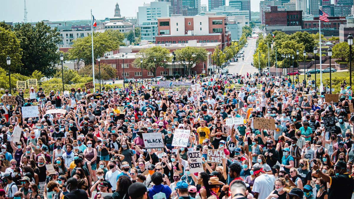Large crowd gathering for Black Lives Matter protest in Des Moines city center, advocating for social justice.