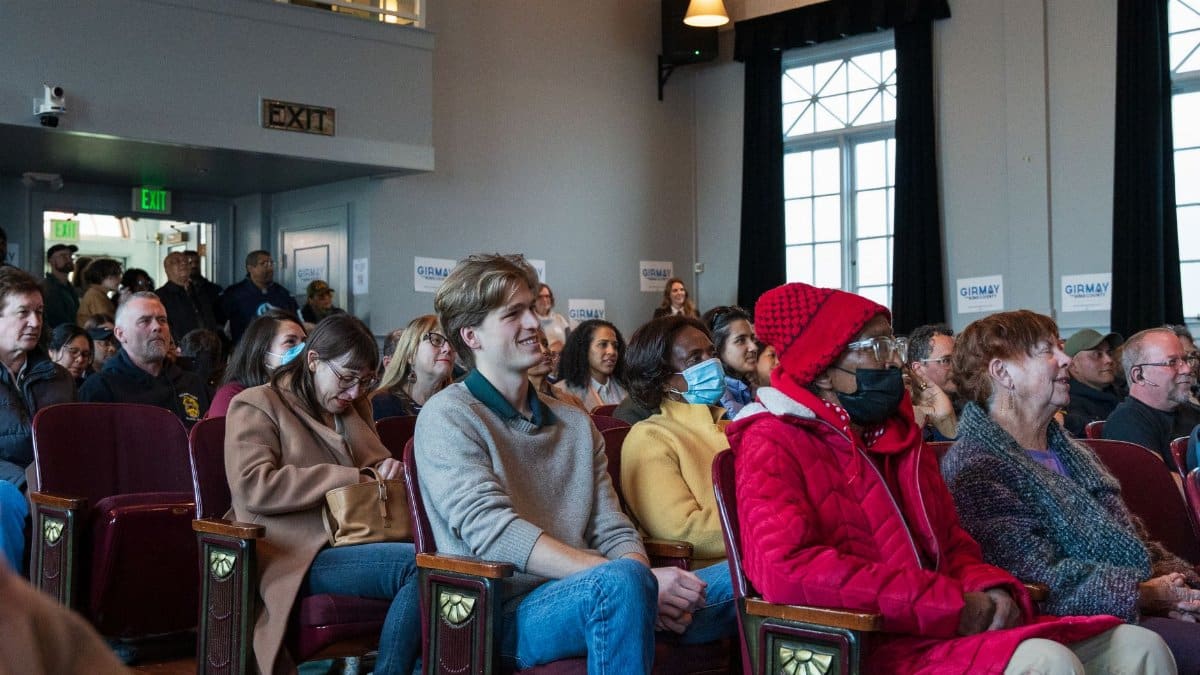 A diverse group of people attending a community meeting in Seattle, Washington.