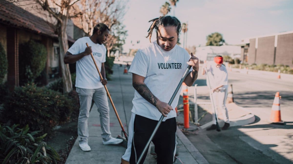 Community volunteers cleaning up streets to promote environmental awareness and social good.