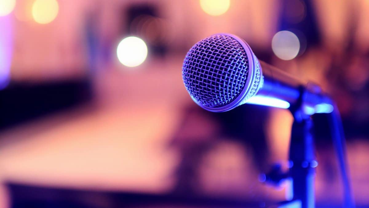 Focused image of a microphone on stage, perfect for events or performances.