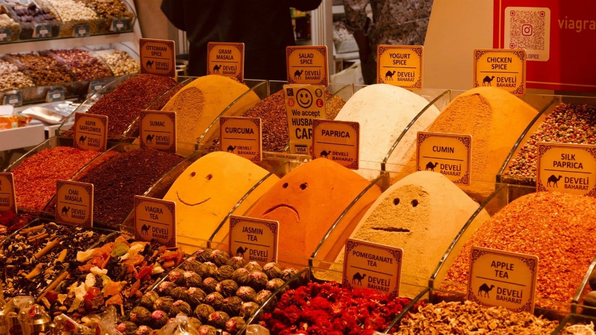 Vibrant spices and teas on display in a bustling market, showcasing diverse flavors.