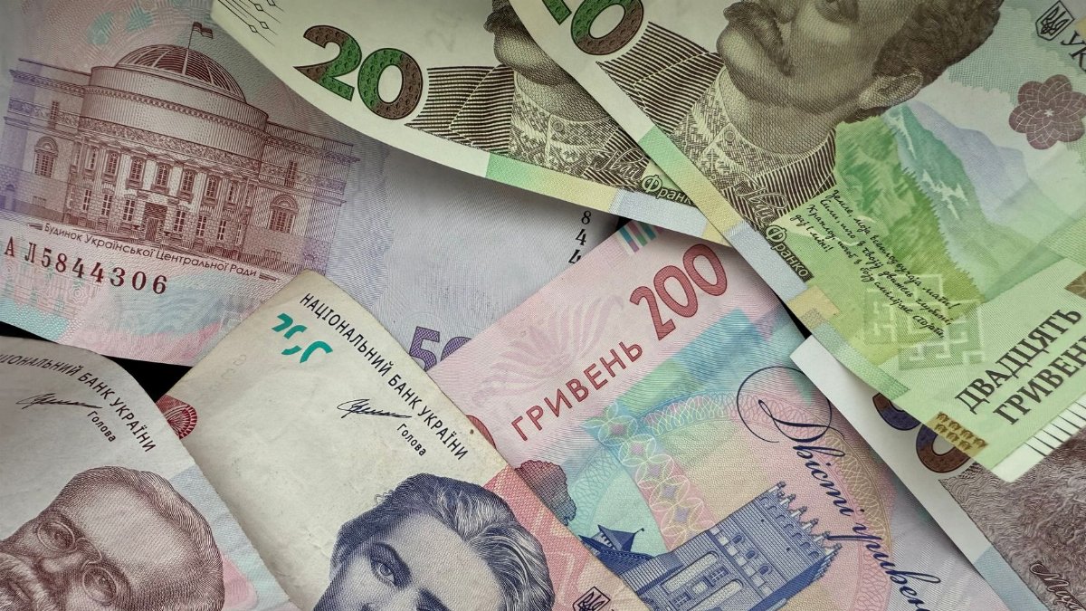 A vibrant assortment of Ukrainian Hryvnia banknotes featuring historical figures and architecture.