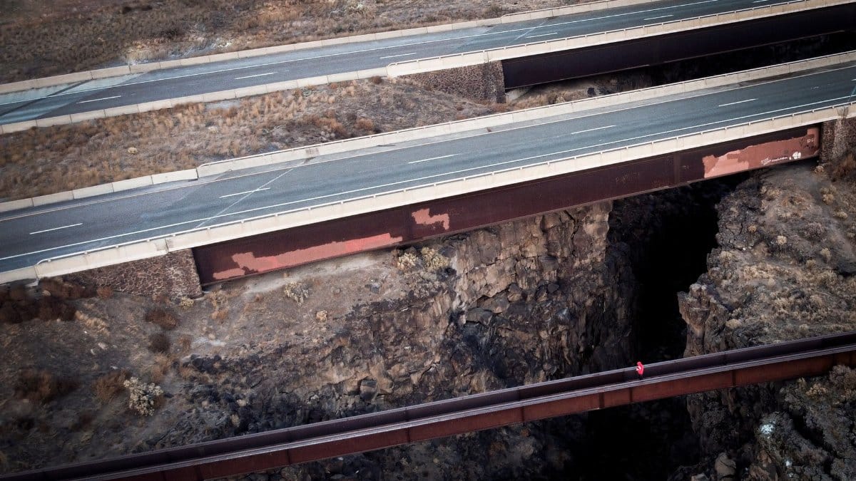 Aerial view of highway bridges spanning a rugged rocky canyon in the United States.