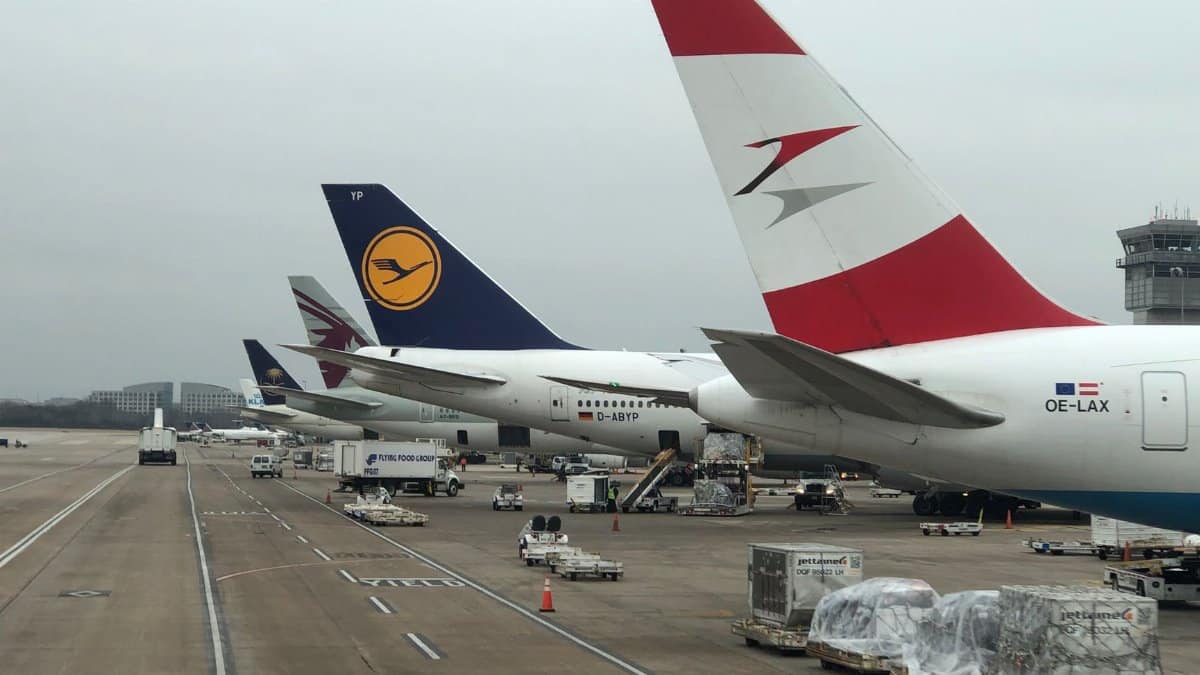 Airplanes parked at Dulles Airport with visible airline logos on a cloudy day.