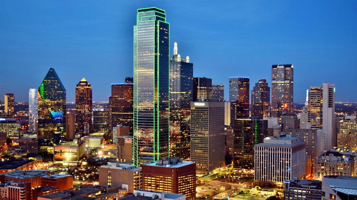 Stunning view of the Dallas skyline at night with illuminated skyscrapers and city lights.