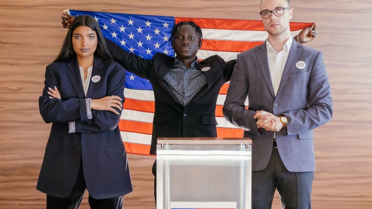 A group of diverse individuals standing confidently in front of an American flag at an election podium.