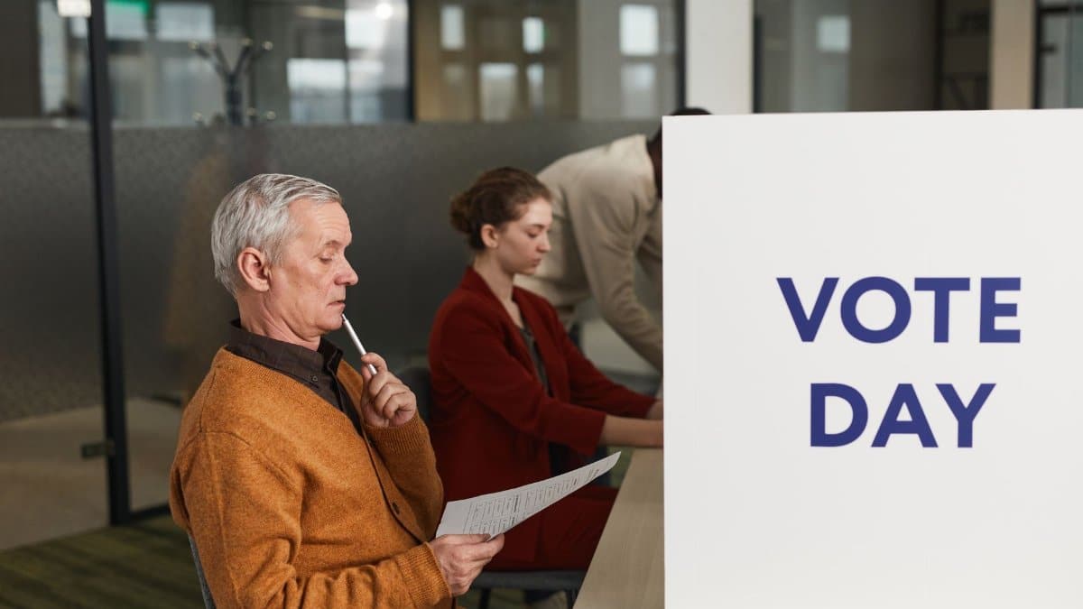 People voting indoors on election day, making decisions at a polling station.
