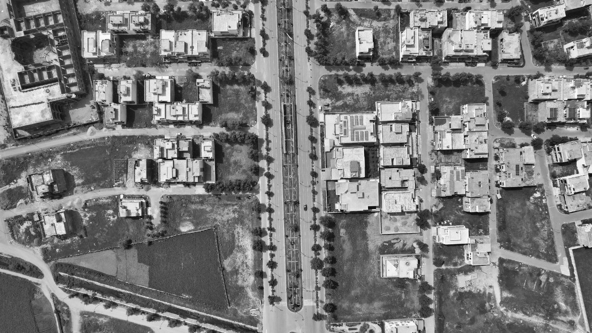 Drone shot of residential area in Gujranwala, Pakistan, capturing urban structure in black and white.