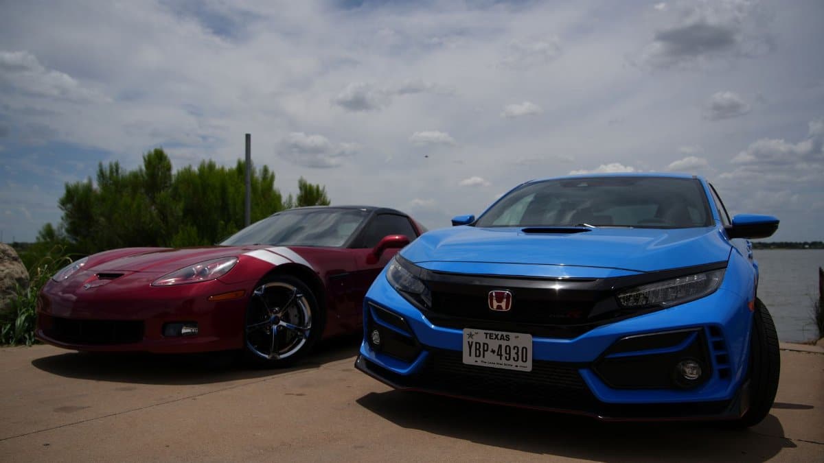 A vibrant display of red and blue sports cars parked by the water in Wichita Falls, Texas.