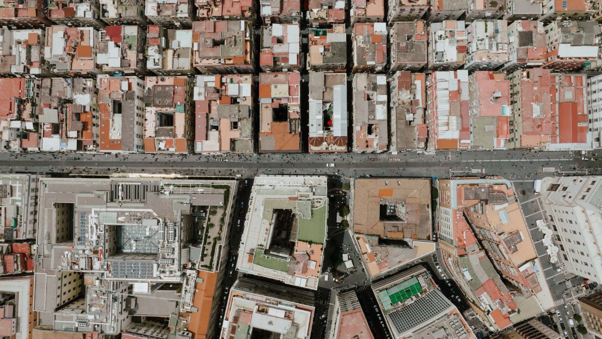 Drone shot capturing the dense urban grid layout of central Naples, Italy.