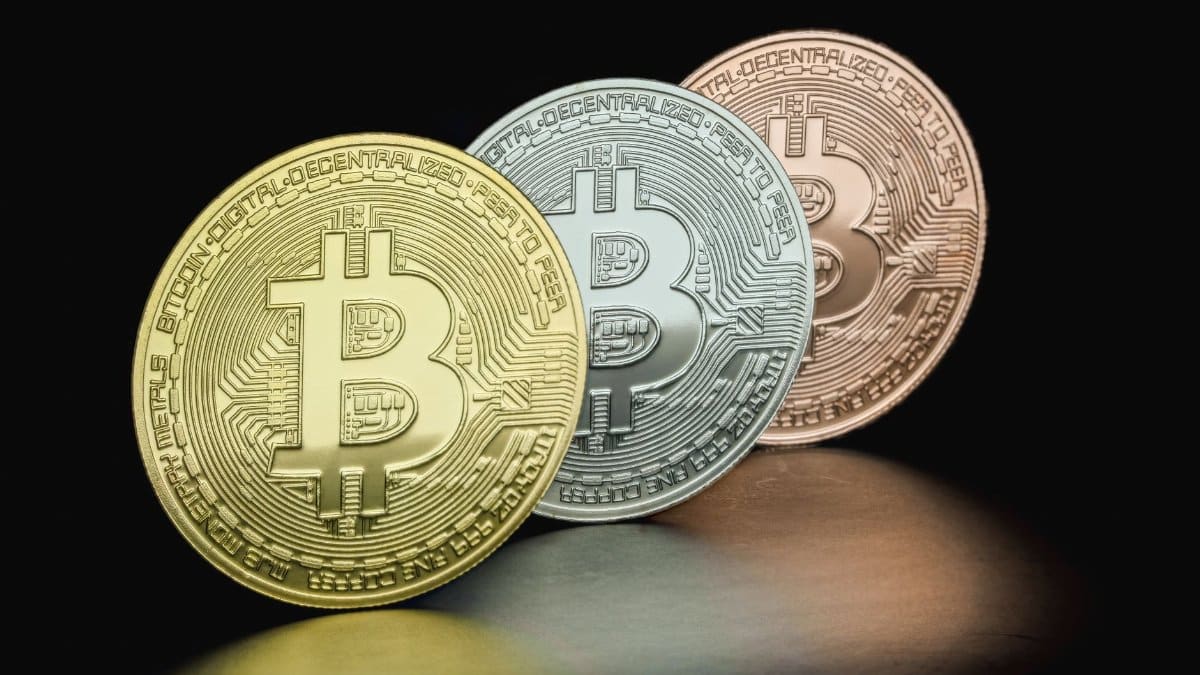 Close-up of Bitcoin coins in gold, silver, and bronze hues depicting cryptocurrency variety.