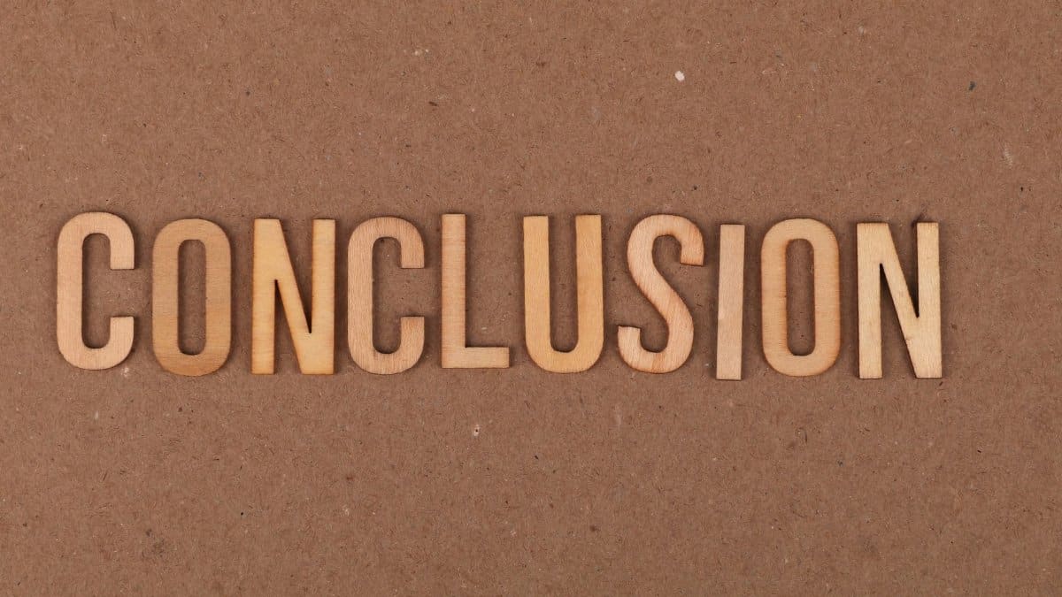Wooden letters arranged to spell 'Conclusion' on a brown cardboard background.