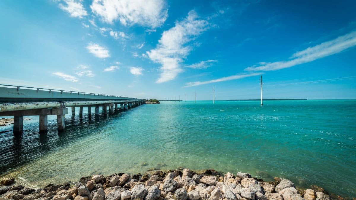 Beautiful ocean view of the Florida Keys with a bridge under a clear blue sky.