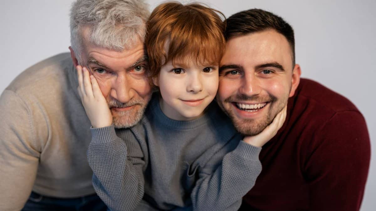 Portrait of three smiling generations, showcasing familial love and togetherness.