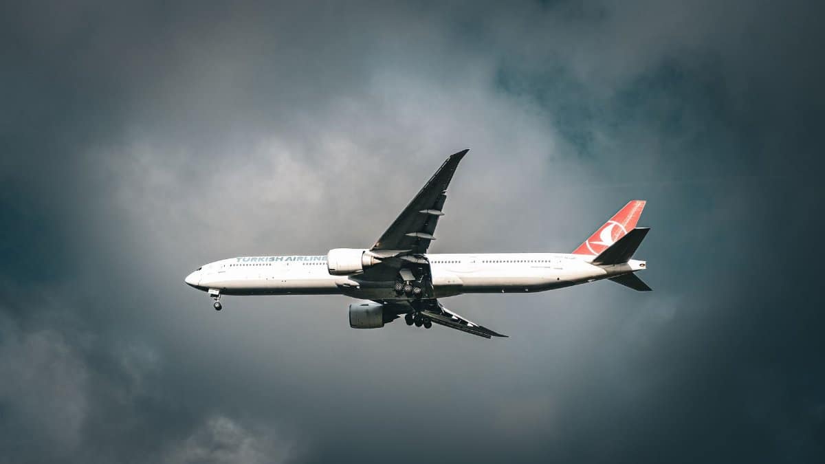 A Turkish Airlines aircraft flying amidst clouds over Istanbul, capturing travel's essence.