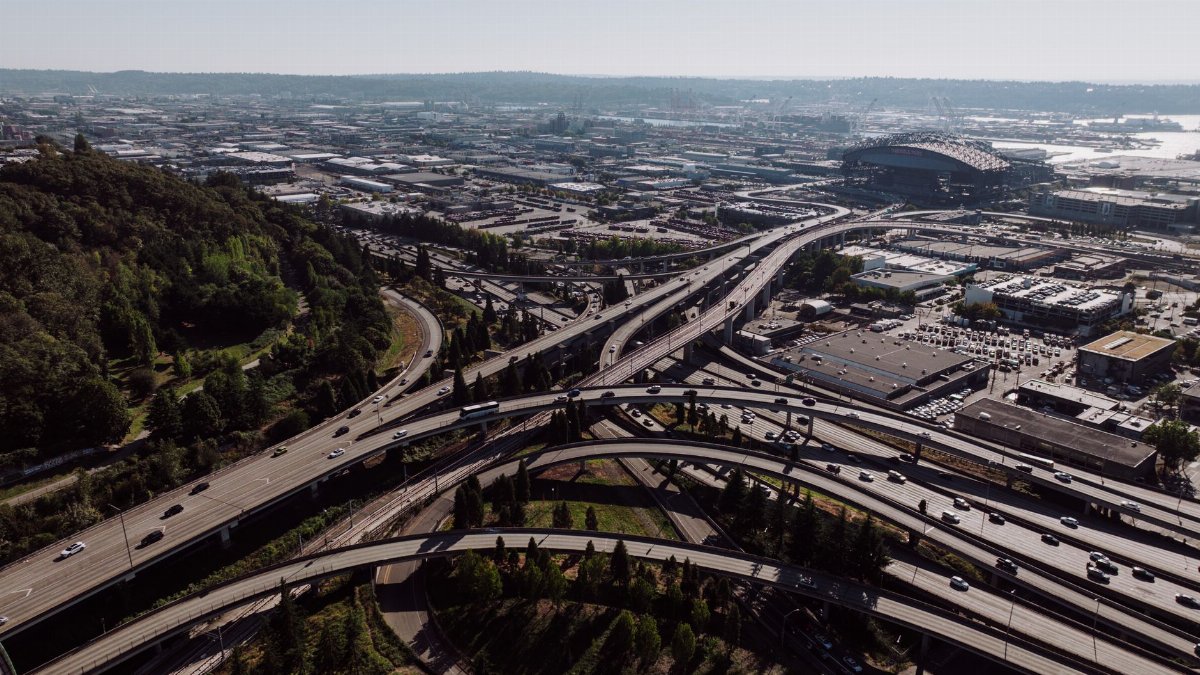 Highway interchange in Seattle with cityscape background, captured during the day.