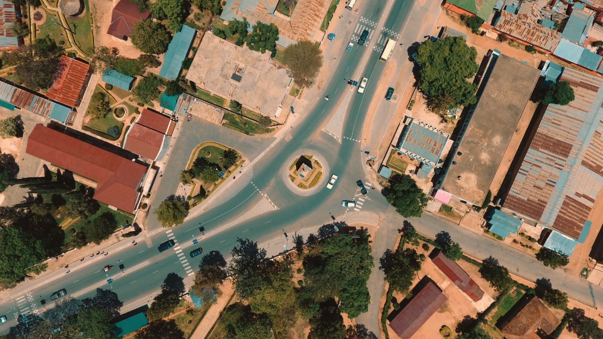 Aerial view of urban roads and buildings in Iringa, Tanzania, showcasing vibrant city life.