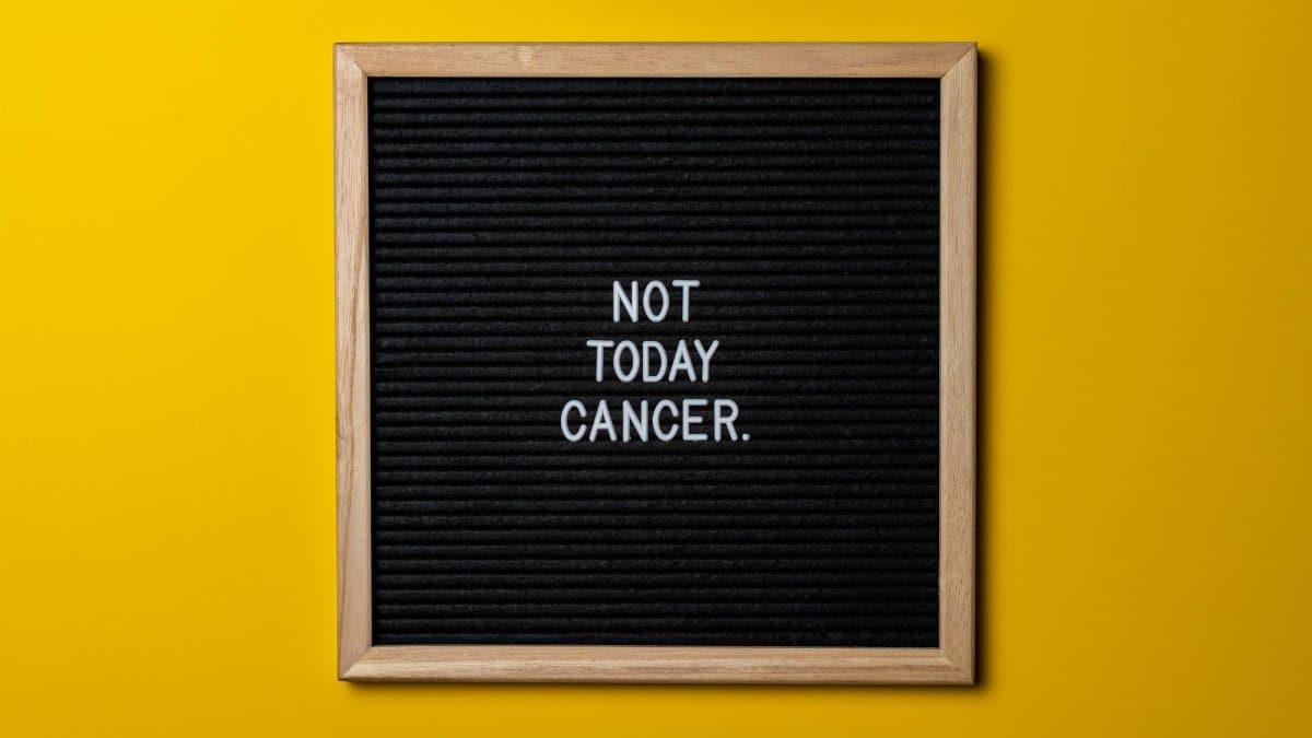Black letter board with 'Not Today Cancer' on yellow backdrop. A motivational health message.