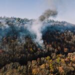 Aerial view of smoke rising over autumn forest near Chattanooga, Tennessee.