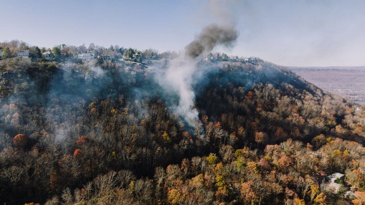Aerial view of smoke rising over autumn forest near Chattanooga, Tennessee.