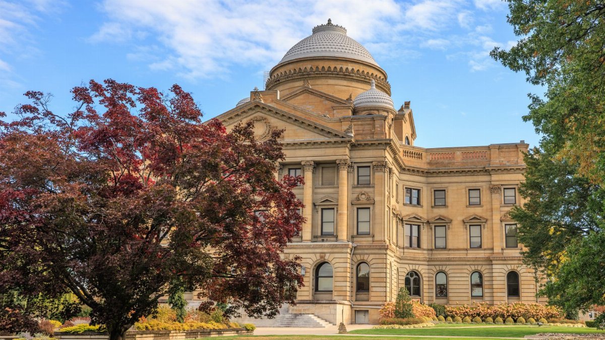 Elegant view of the Luzerne County Courthouse surrounded by autumn foliage under a clear blue sky.