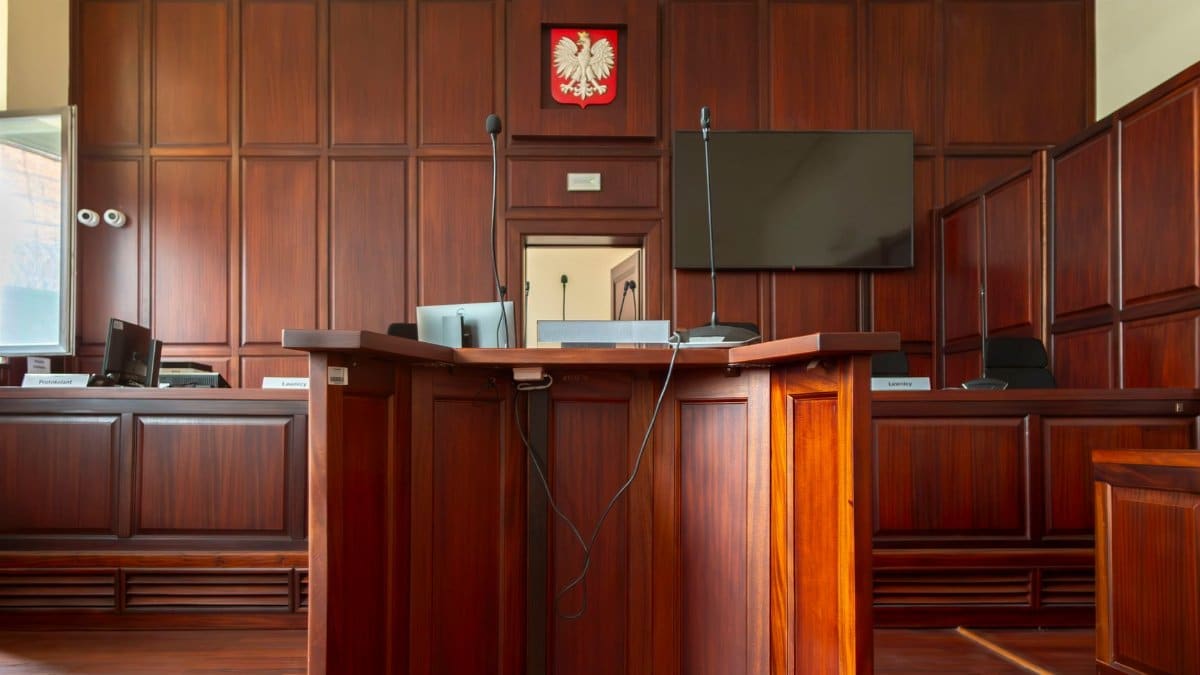 A detailed view of a courtroom interior in Wrocław, Poland, showcasing the judge's bench and national emblem.