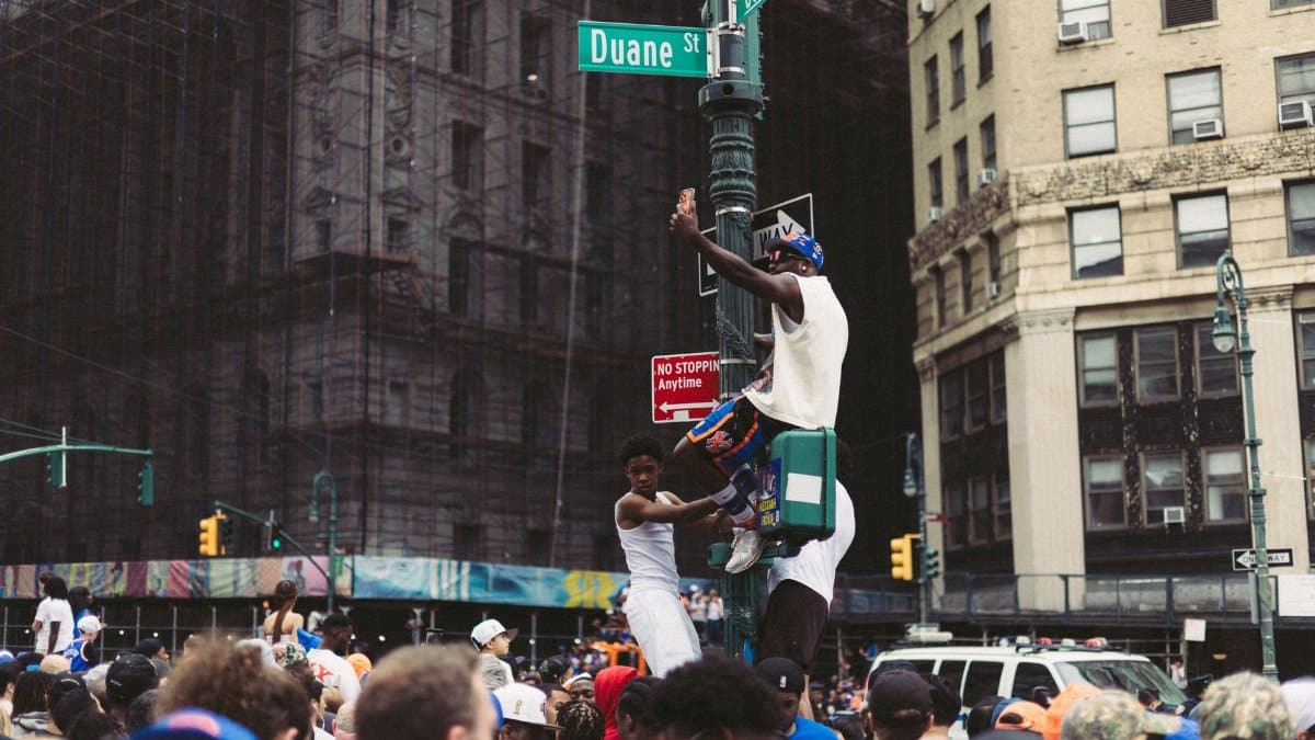 Energetic crowd gathered at Duane Street in New York City, showcasing urban celebration and street life.