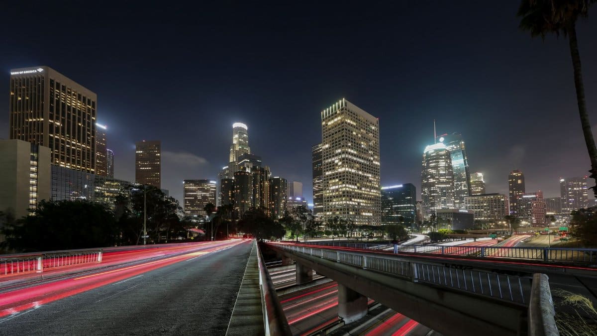 Vibrant long exposure of Downtown Los Angeles skyscrapers at night, showcasing the city skyline.