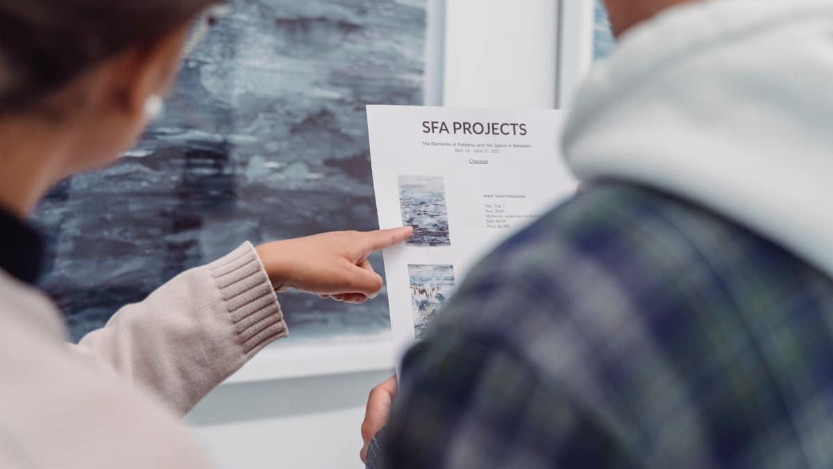 Close-up of a document being pointed at, discussing SFA projects.