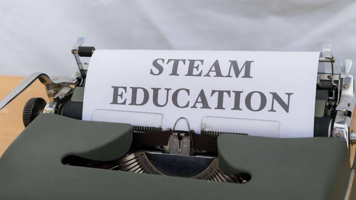 Close-up of a vintage typewriter displaying 'STEAM Education' on a sheet of paper. Ideal for educational content.