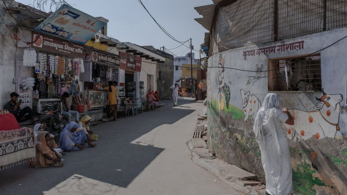 Local life captured in a bustling street of Gobardhan, showcasing shops and daily activities.