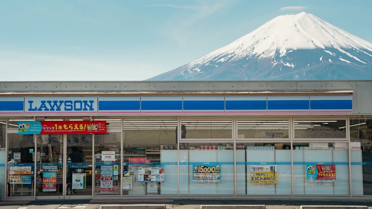 A Lawson convenience store with Mount Fuji in the background, showcasing Japan's iconic landscape.