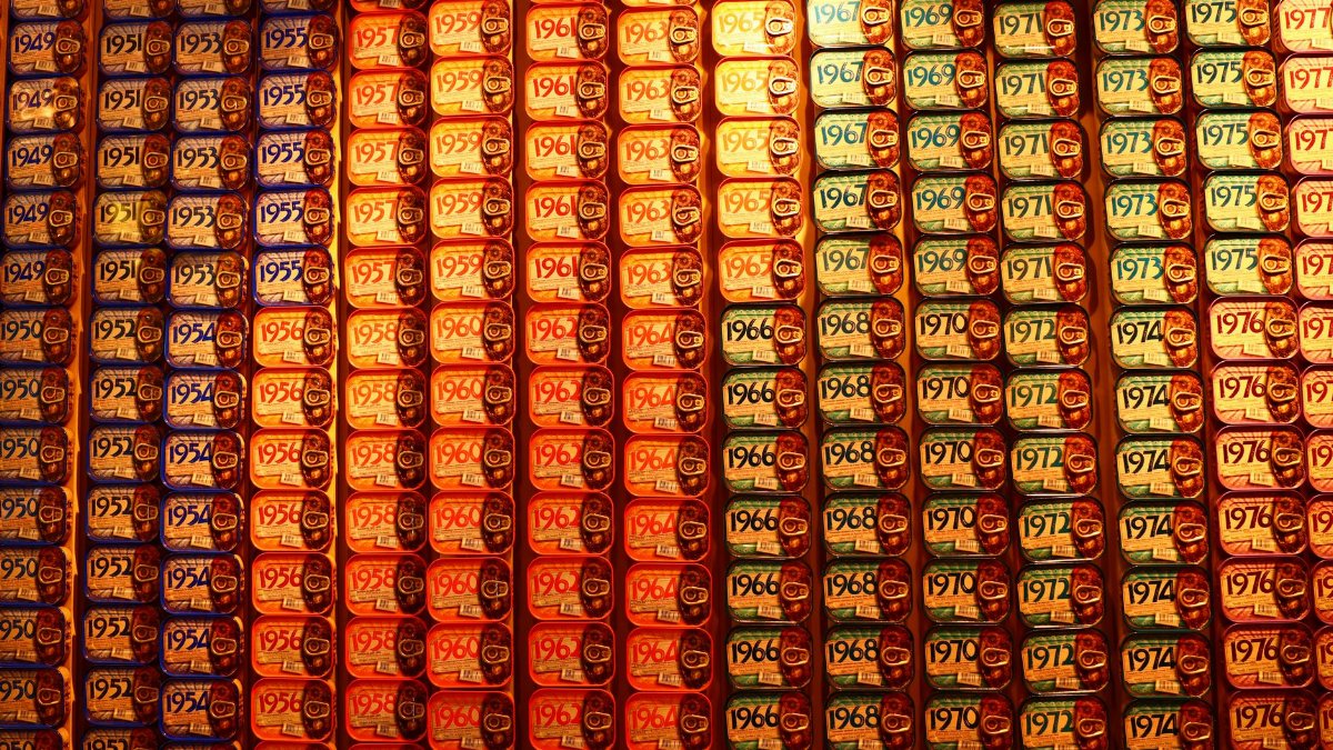 Vibrant display of sardine cans with various years, creating a vintage aesthetic.